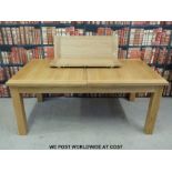 A contemporary light oak dining table with two extra leaves (min length 181cm, max 256cm,