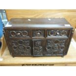 An oak carved miniature or apprentice chest/ sideboard with columns to corners,