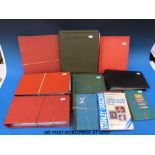 A box containing various first day cover albums, albums of world stamps,