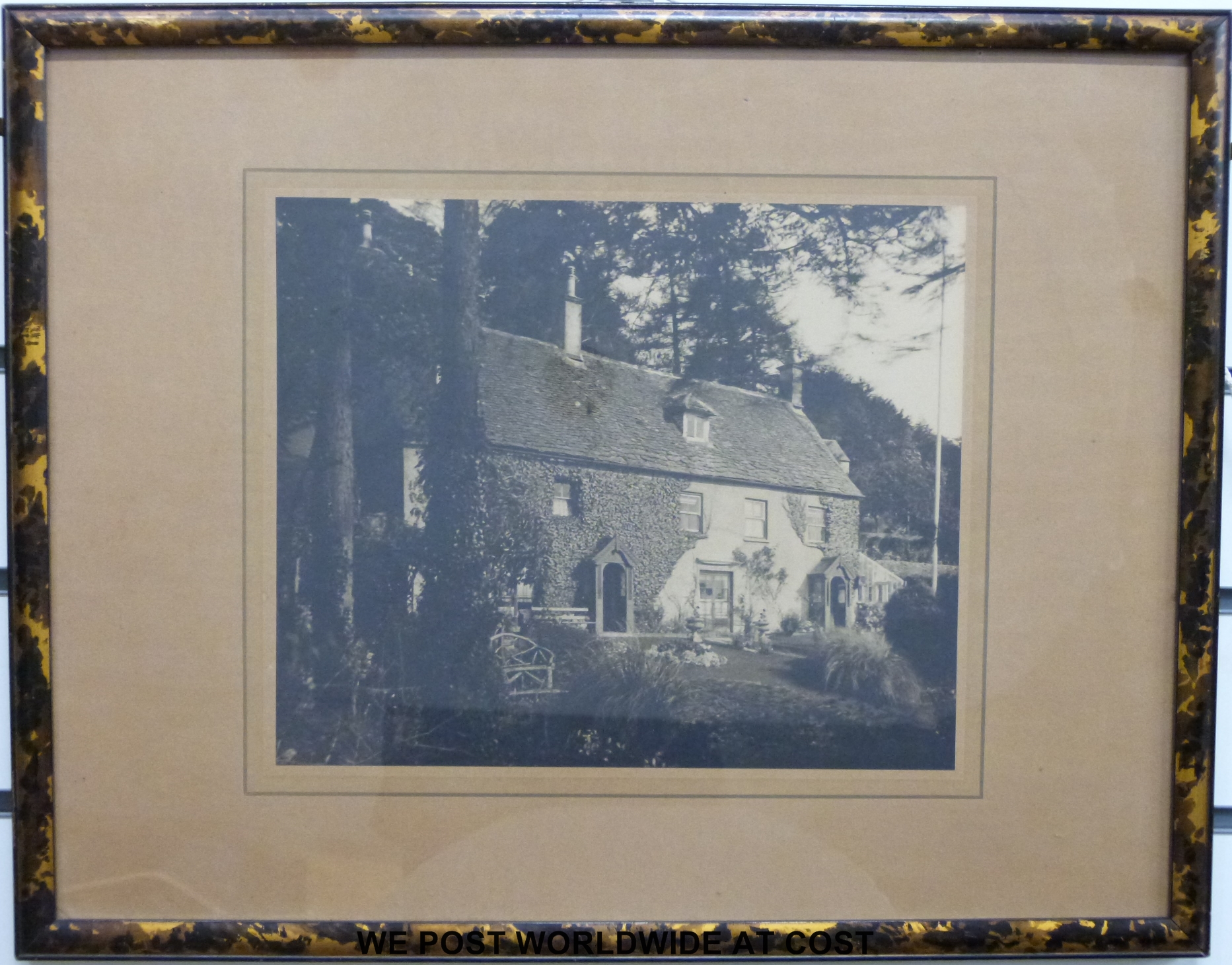 A tortoiseshell effect picture frame containing a picture of The Firs, Theescombe,