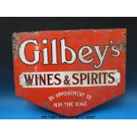 A double sided enamel advertising sign 'Gilbey's Wines and Spirits by appointment to H M The King'