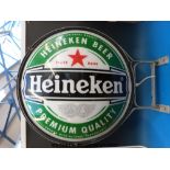 A double sided Heineken advertising sign with internal light (82cm diameter)