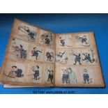 A vintage scrap album containing late 19thC comic strips with hand written text dated 1879 plus