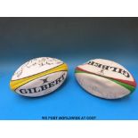 Two signed rugby balls.