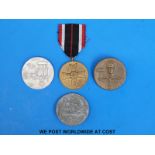 Three 1930's Nazi German rally badges or 'tinnies' together with a 1939 Merit medal