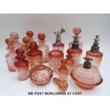 A set of eight graduated wrythen moulded amberina glass scent bottles,