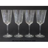 A set of four Royal Doulton wine glasses decorated with flowers (21cm tall)