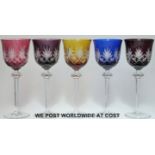 A set of five flash overlaid cut glass wine glasses raised on hexagonal stems with multi-faceted