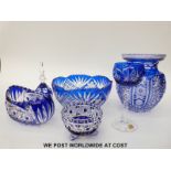 Six pieces of blue flash overlaid cut glassware comprising three bowls, bell,