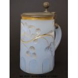 An opaline glass tankard with incised gilt decoration and pewter mounts (16cm tall)