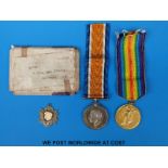 A pair of WWI medals awarded to 65202 Pte E.G.Tyler Devon Regiment and a silver fob for the G.S.F.