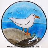 A stained glass charger decorated with a seagull,