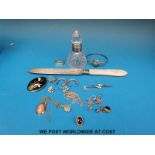 A silver bladed, mother of pearl handled knife and a silver rimmed cut glass scent bottle,