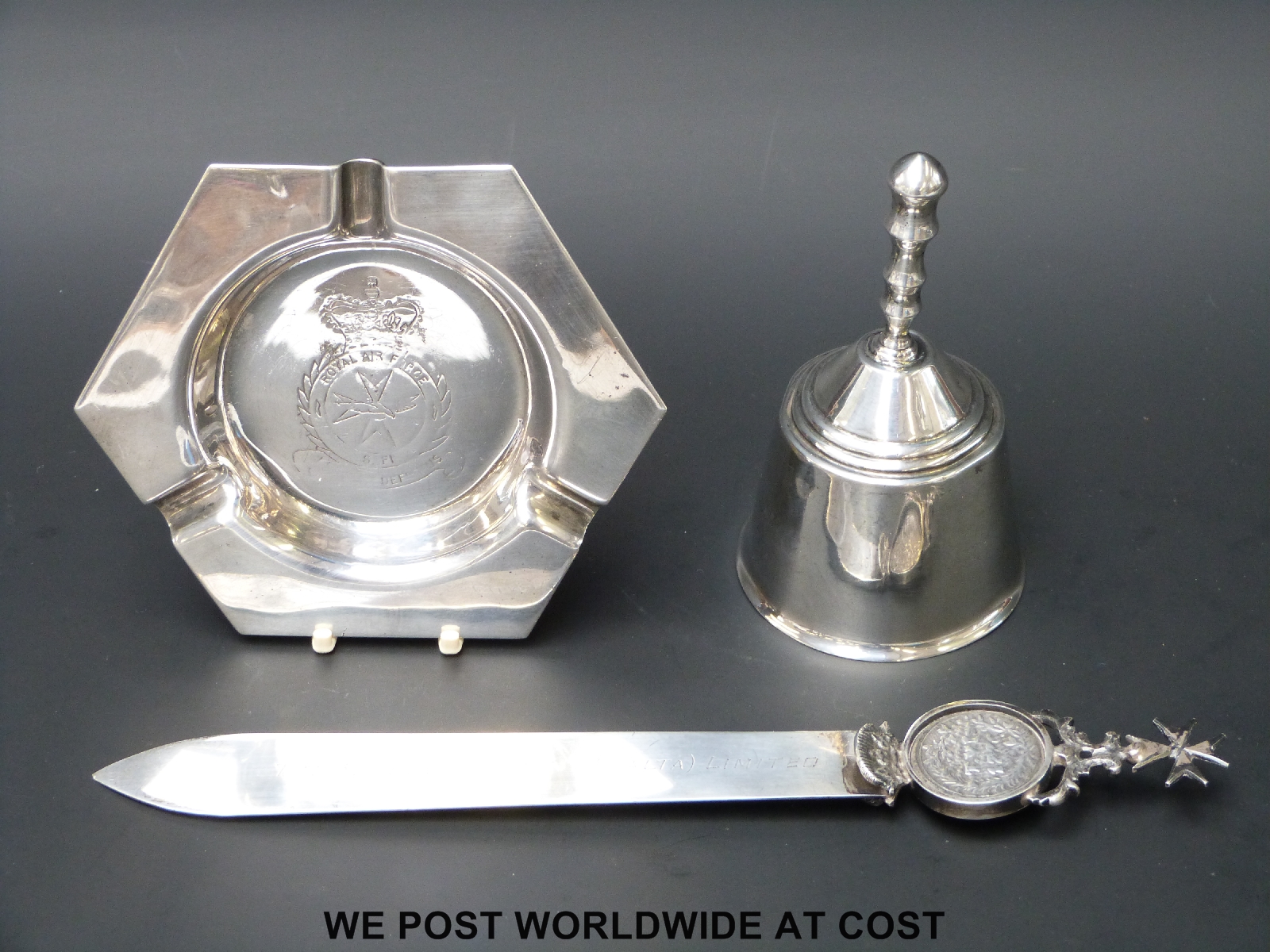 A white metal letter opener with inscription "The Shell Company (Malta) Limited" and stamped 917