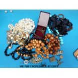 A quantity of costume jewellery to include bead necklaces, stamp case marked sterling silver,