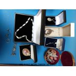 A collection of silver jewellery to include a locket, necklaces, necklaces, ring,