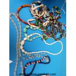 A quantity of beaded necklaces to include glass, ivory, wooden,