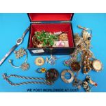 A small jewellery box containing a quantity of costume jewellery to include Miracle and Exquisite