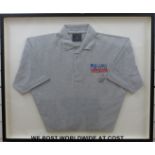 A Lewis Hamilton signed polo shirt in frame