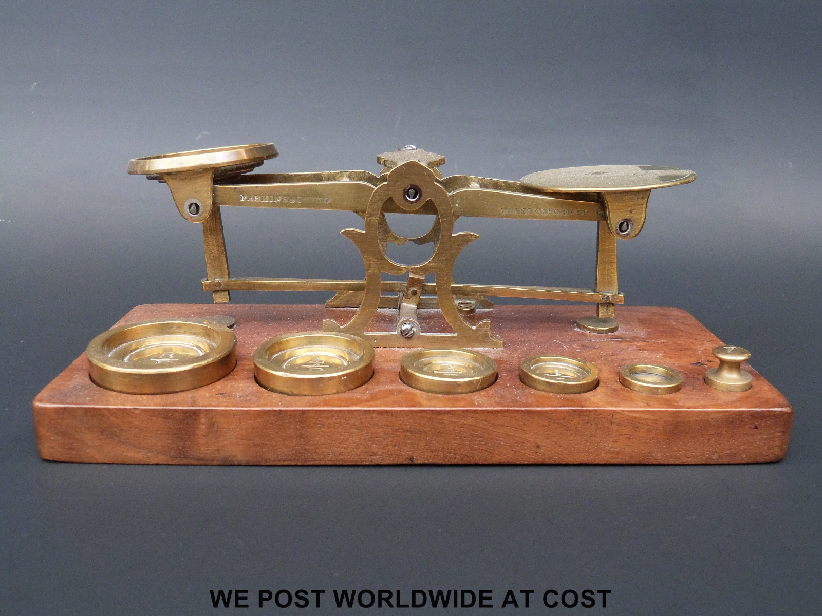 A set of Parkins & Gotto postage scales on wooden base with weights