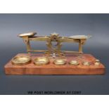A set of Parkins & Gotto postage scales on wooden base with weights