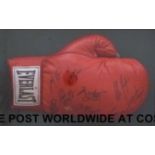 An Everlast boxing glove signed Muhammed Ali, Larry Holmes, Riddick Bowe, Evander Holyfield,