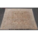 A large wool rug with floral decoration on beige ground (360cm x 273cm)