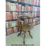 An early 20thC elm seated swivel/office chair