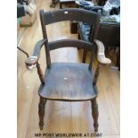 A Victorian elm seated elbow chair