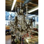 Three gilt metal chandeliers with drop decorations