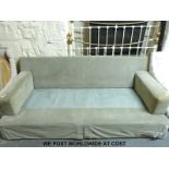 A three seat sofa with light green upholstery