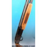 A deactivated Mossburg Slugster pump action shotgun with engraved detail of a stag,