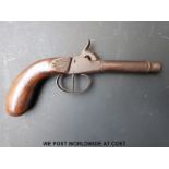 Single barrelled percussion hammer action pocket pistol with carved grip and cannon shaped barrel,