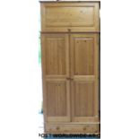A pine wardrobe with cupboard above and drawer below (W95 D58 H219cm)