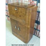 An Art Deco burr walnut drinks or cocktail cabinet with fitted mirrored interior to top section