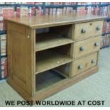 A vintage pine haberdashery shop counter with three straight drawers and three cubbyholes.