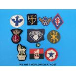 A collection of military cloth and cloth backed badges to include Naval,