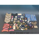 A quantity of British military insignia to include cap badges, cloth,