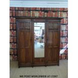 An oak three door wardrobe or compactum with drawers to interior (W190 D52 H207cm)