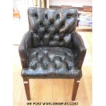A black leather chair with button back and seat