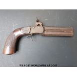 Double barrelled over and under percussion hammer action pocket pistol with carved and chequered