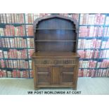 An oak dresser with Dutch style top and two drawers and cupboards to base (W111 D48 H180cm)