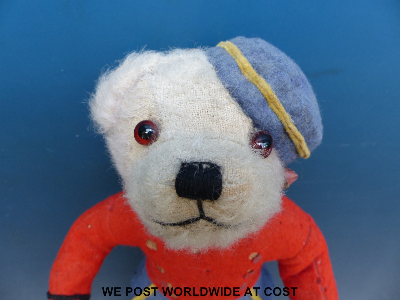 A straw filled teddy bear in red, blue and yellow railway uniform with matching hat, 35cm tall. - Image 3 of 3