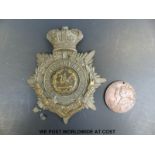 A 1937 coronation medal and South Wales Borderers badge.