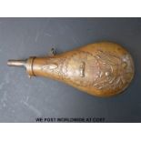 A copper powder flask with embossed decoration of a US crest with shaking hands and eagle above,