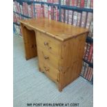 A pine desk with three drawers to one side (W100 D44 H75cm)