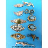 A collection of brooches to include two filigree, silver and paste, miracle etc.