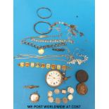 A tin containing costume jewellery to include silver bracelet, yellow metal brooch, two coins,