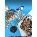 A large collection of costume jewellery to include brooches, necklaces, beads, earrings,