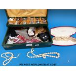 A jewellery box containing two ivory necklaces,